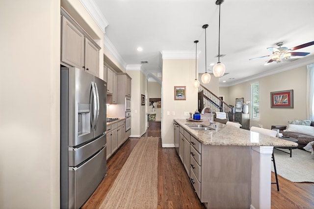 3303 New Garden View Ln, Houston, TX 77018 - kitchen featuring stainless steel appliances, a sink, open floor plan, a breakfast bar, and gray cabinetry