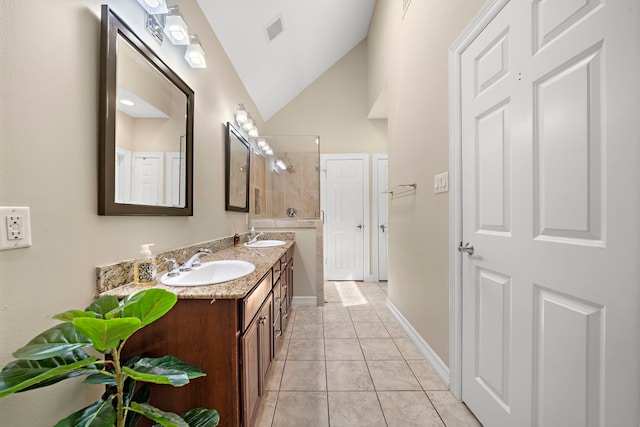 3303 New Garden View Ln, Houston, TX 77018 - bathroom featuring double vanity, vaulted ceiling, tile patterned floors, baseboards, and a shower