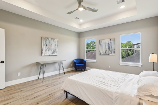 3722 Nathaniel Brown St, Houston, TX 77021 - bedroom with a raised ceiling, wood finished floors, multiple windows, baseboards, and recessed lighting