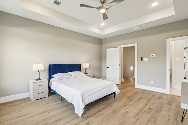3722 Nathaniel Brown St, Houston, TX 77021 - bedroom featuring a tray ceiling, baseboards, light wood finished floors, recessed lighting, and a ceiling fan