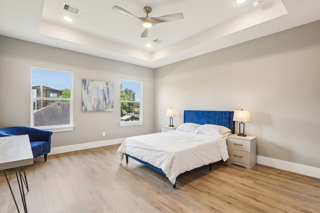 3722 Nathaniel Brown St, Houston, TX 77021 - bedroom featuring a raised ceiling, light wood finished floors, baseboards, and recessed lighting