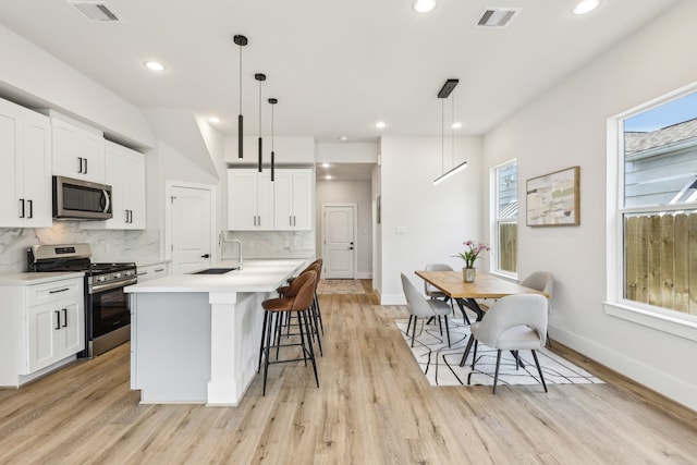 3722 Nathaniel Brown St, Houston, TX 77021 - kitchen featuring stainless steel appliances, a sink, healthy amount of natural light, light wood-type flooring, and recessed lighting