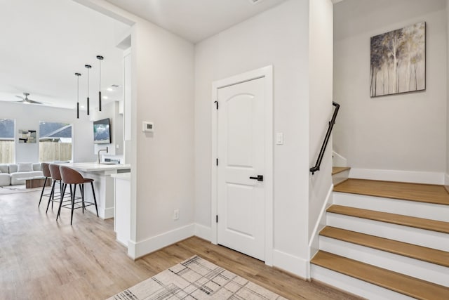 3722 Nathaniel Brown St, Houston, TX 77021 - foyer entrance featuring light wood finished floors, a ceiling fan, baseboards, and stairway
