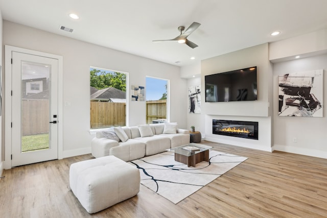 3722 Nathaniel Brown St, Houston, TX 77021 - living area featuring a glass covered fireplace, ceiling fan, wood finished floors, baseboards, and recessed lighting