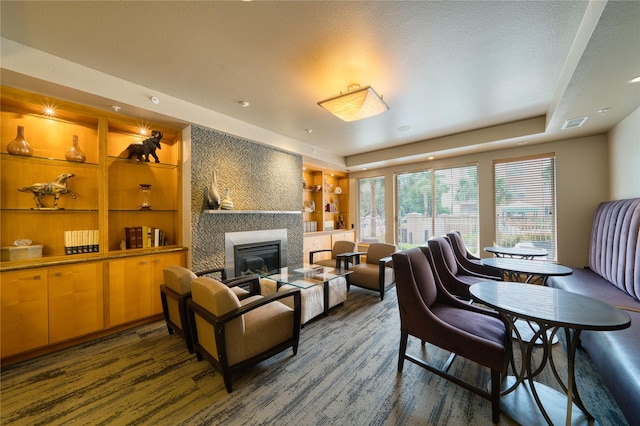 3505 Sage Rd Unit 2405, Houston, TX 77056 - living area featuring wood finished floors, a large fireplace, built in features, and a textured ceiling