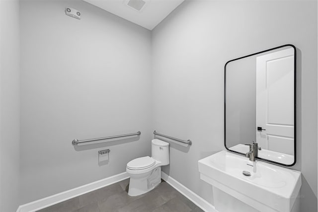 1325 Main St Unit 1103, Katy, TX 77494 - bathroom with toilet, baseboards, a sink, and tile patterned floors