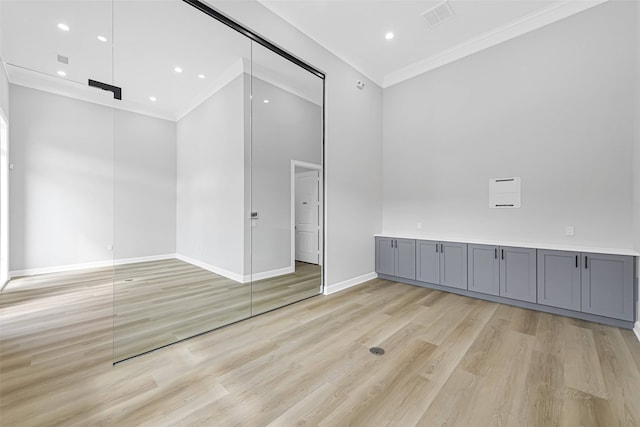 1325 Main St Unit 1103, Katy, TX 77494 - unfurnished room with crown molding, light wood-style floors, baseboards, and recessed lighting