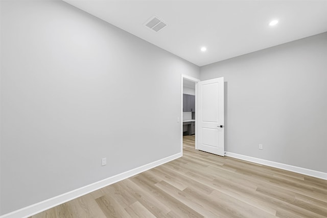 1325 Main St Unit 1103, Katy, TX 77494 - unfurnished room featuring baseboards, light wood-style flooring, and recessed lighting