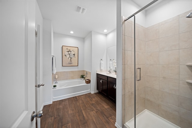 3313 Cold Swan Ct, Conroe, TX 77301 - bathroom with a shower stall, a bath, wood finished floors, vanity, and recessed lighting
