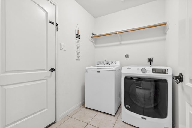20423 Barrel Run Dr, Hockley, TX 77447 - laundry room featuring independent washer and dryer, light tile patterned floors, and baseboards