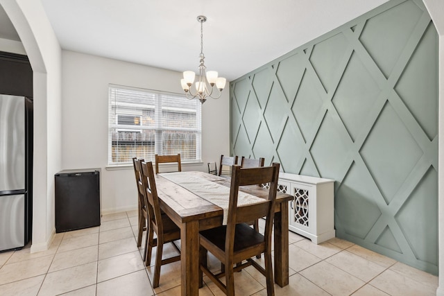 20423 Barrel Run Dr, Hockley, TX 77447 - dining space featuring a chandelier, arched walkways, light tile patterned floors, and baseboards