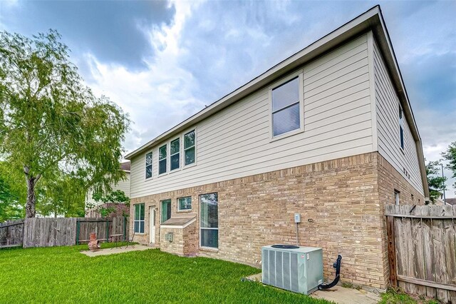 15131 Live Oak Bend Way, Cypress, TX 77429 - rear view of property featuring central AC and brick siding