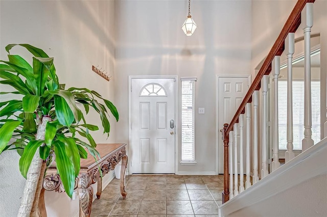15131 Live Oak Bend Way, Cypress, TX 77429 - foyer entrance with stairway, a towering ceiling, light tile patterned floors, and baseboards