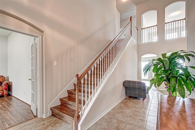 15131 Live Oak Bend Way, Cypress, TX 77429 - stairs featuring tile patterned flooring, baseboards, and a high ceiling