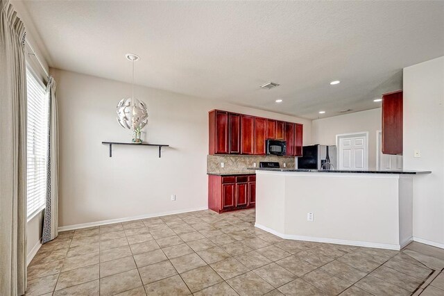 15131 Live Oak Bend Way, Cypress, TX 77429 - kitchen with dark brown cabinets, black microwave, refrigerator with ice dispenser, decorative backsplash, and dark countertops