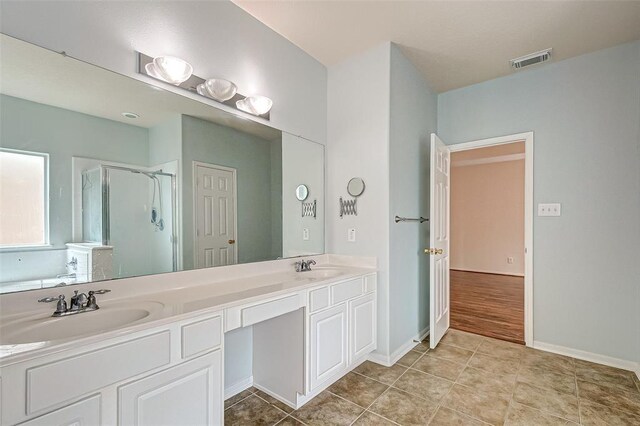 15131 Live Oak Bend Way, Cypress, TX 77429 - bathroom with a shower stall, double vanity, and baseboards