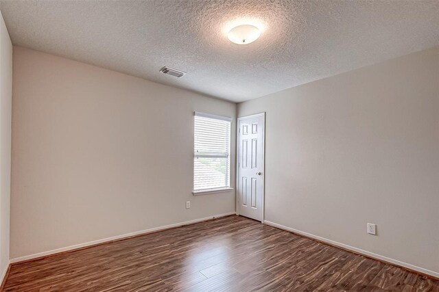 15131 Live Oak Bend Way, Cypress, TX 77429 - spare room with dark wood-style flooring, baseboards, and a textured ceiling