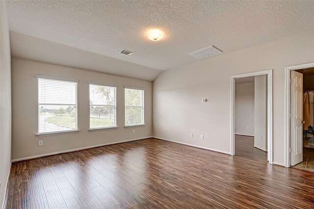 15131 Live Oak Bend Way, Cypress, TX 77429 - spare room featuring dark wood finished floors, lofted ceiling, a textured ceiling, and baseboards