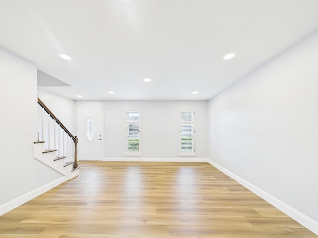 10380 Briar Forest Dr Unit 32/6, Houston, TX 77042 - unfurnished living room featuring stairway, light wood finished floors, baseboards, and recessed lighting