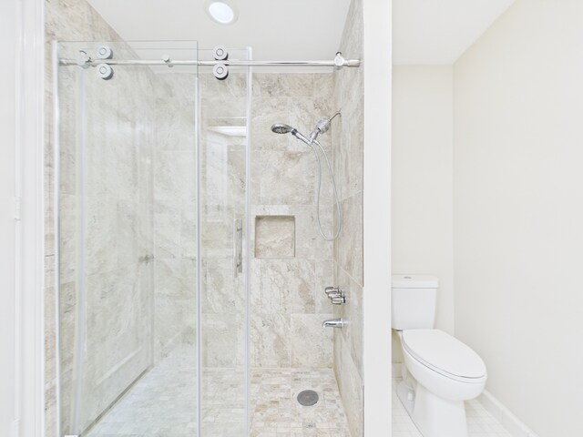 7608 Del Monte Dr, Houston, TX 77063 - full bath featuring a stall shower, toilet, tile patterned floors, and baseboards