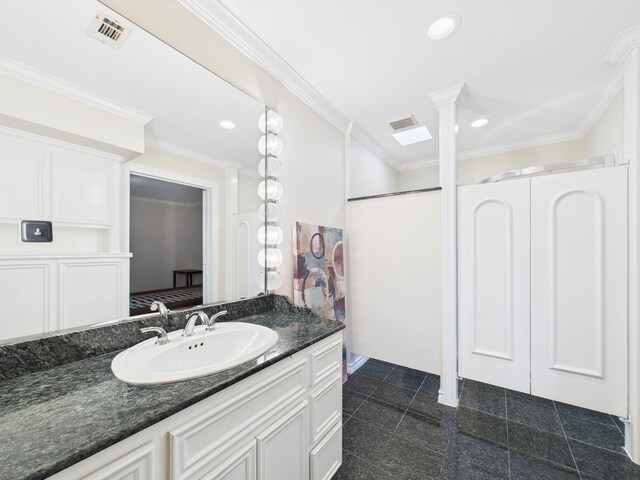 7608 Del Monte Dr, Houston, TX 77063 - bathroom with vanity, recessed lighting, ornamental molding, and decorative columns