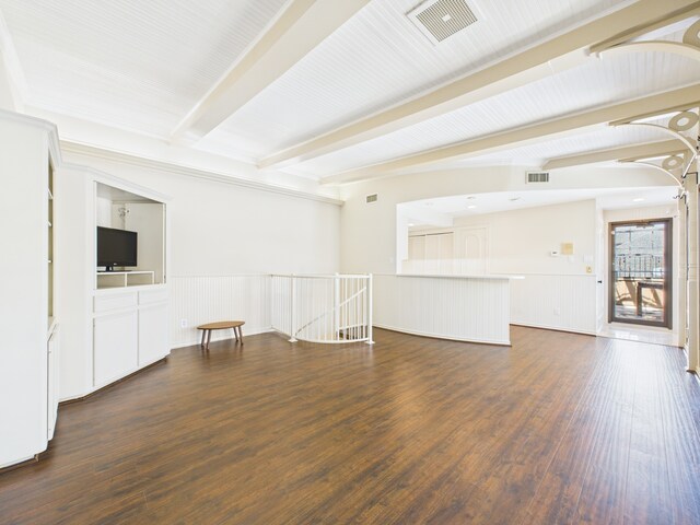7608 Del Monte Dr, Houston, TX 77063 - unfurnished living room featuring beamed ceiling, dark wood-type flooring, and a wainscoted wall