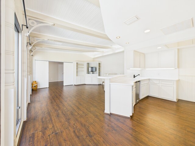 7608 Del Monte Dr, Houston, TX 77063 - kitchen featuring open floor plan, a peninsula, dark wood-style flooring, light countertops, and beamed ceiling