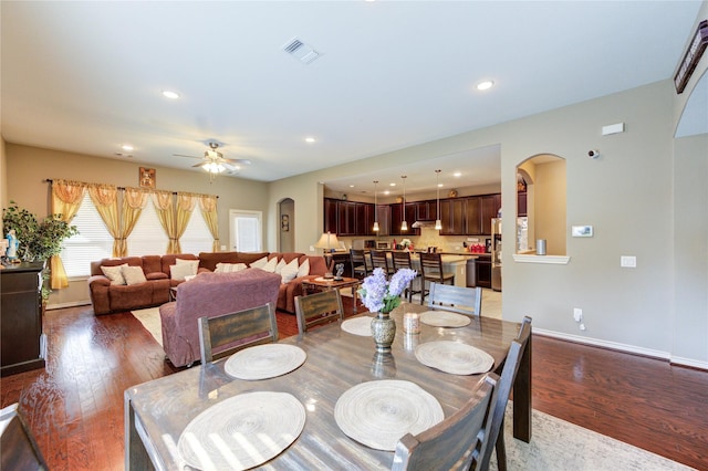 9710 Wild Orange Ct, Spring, TX 77379 - dining space with arched walkways, dark wood-type flooring, baseboards, recessed lighting, and ceiling fan