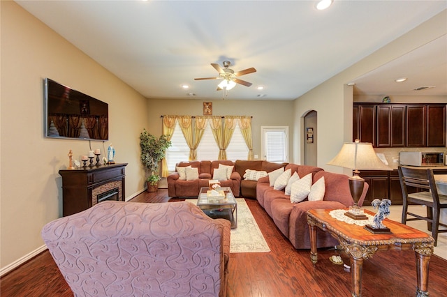 9710 Wild Orange Ct, Spring, TX 77379 - living area featuring ceiling fan, arched walkways, dark wood-style flooring, recessed lighting, and baseboards