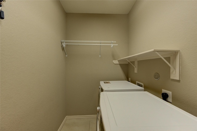 9710 Wild Orange Ct, Spring, TX 77379 - laundry area with washer / clothes dryer, baseboards, and tile patterned flooring