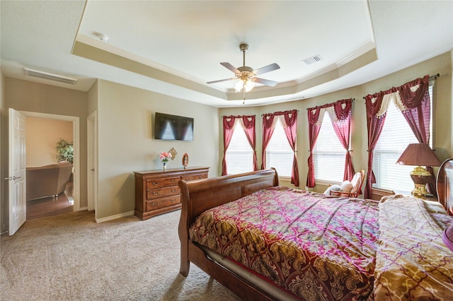 9710 Wild Orange Ct, Spring, TX 77379 - bedroom with a tray ceiling, light carpet, baseboards, ornamental molding, and ceiling fan
