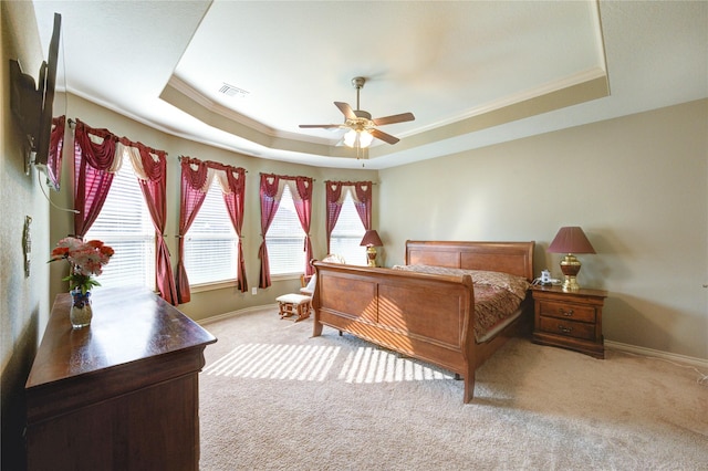 9710 Wild Orange Ct, Spring, TX 77379 - bedroom with a tray ceiling, carpet flooring, multiple windows, crown molding, and baseboards
