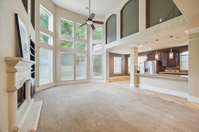 14603 Hampton Green Ln, Houston, TX 77044 - unfurnished living room with ceiling fan, a premium fireplace, light carpet, baseboards, and a towering ceiling