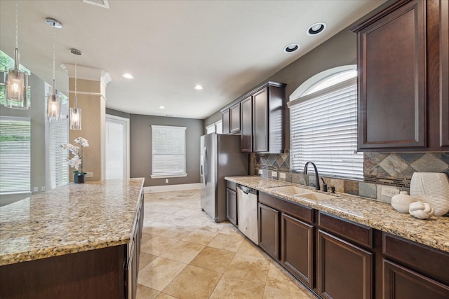 14603 Hampton Green Ln, Houston, TX 77044 - kitchen featuring a sink, stainless steel appliances, tasteful backsplash, dark brown cabinets, and healthy amount of natural light