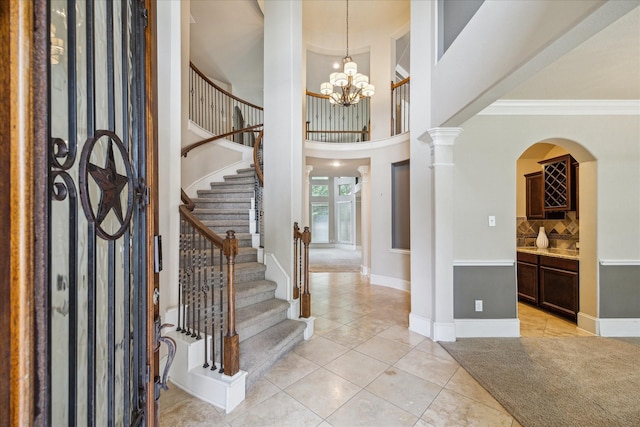 14603 Hampton Green Ln, Houston, TX 77044 - entrance foyer with light tile patterned floors, stairs, baseboards, a chandelier, and ornamental molding