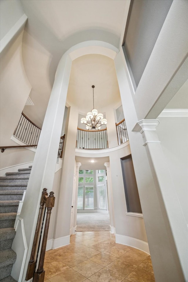 14603 Hampton Green Ln, Houston, TX 77044 - foyer with decorative columns, stairs, a chandelier, baseboards, and a towering ceiling