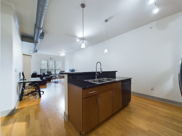 1901 Post Oak Blvd Unit 2215, Houston, TX 77056 - kitchen featuring a sink, black dishwasher, dark countertops, track lighting, and light wood finished floors
