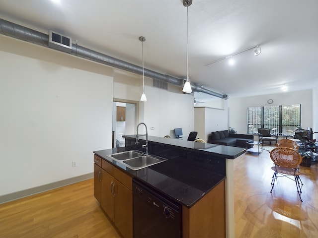 1901 Post Oak Blvd Unit 2215, Houston, TX 77056 - kitchen featuring black dishwasher, a sink, dark countertops, and light wood finished floors