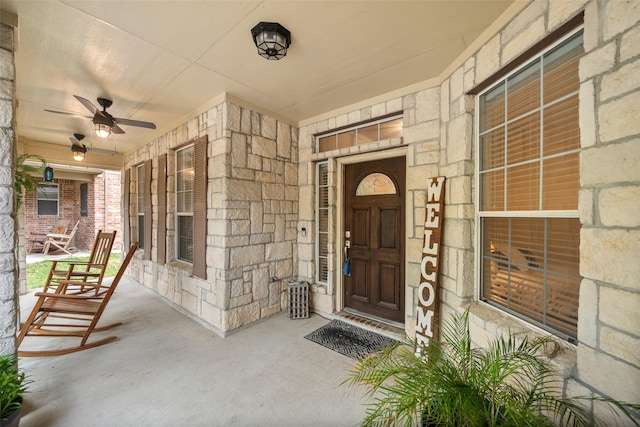 31318 Evergreen Park Ln, Conroe, TX 77385 - entrance to property with covered porch, stone siding, and a ceiling fan