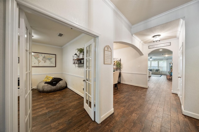 31318 Evergreen Park Ln, Conroe, TX 77385 - hallway with ornamental molding, hardwood / wood-style floors, arched walkways, french doors, and baseboards