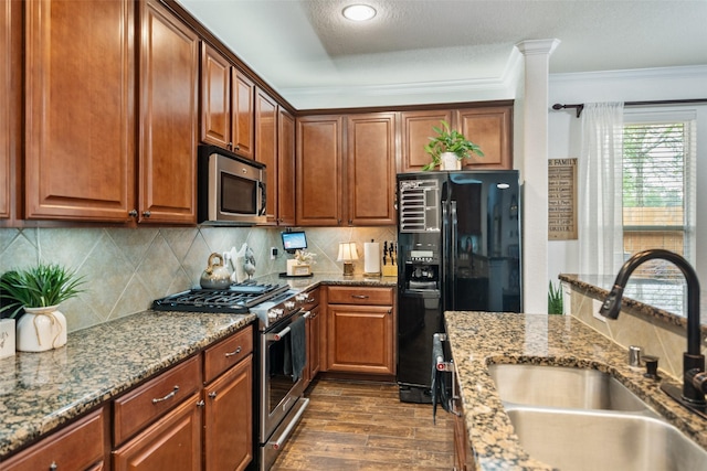 31318 Evergreen Park Ln, Conroe, TX 77385 - kitchen with stainless steel appliances, a sink, tasteful backsplash, stone countertops, and crown molding