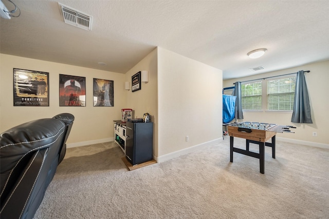 31318 Evergreen Park Ln, Conroe, TX 77385 - recreation room with light colored carpet, baseboards, and a textured ceiling