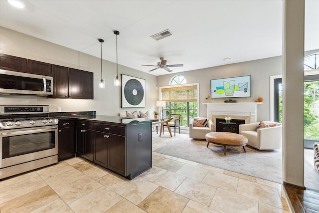 19 Crestwood Dr Unit 4, Houston, TX 77007 - kitchen featuring appliances with stainless steel finishes, dark countertops, healthy amount of natural light, a fireplace, and recessed lighting