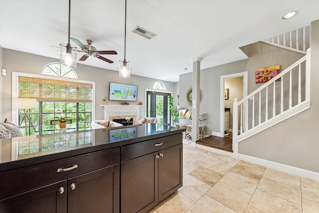 19 Crestwood Dr Unit 4, Houston, TX 77007 - kitchen featuring a ceiling fan, dark brown cabinets, healthy amount of natural light, and a fireplace