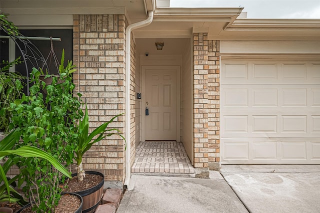 8143 Solara Bnd, Houston, TX 77083 - doorway to property with a garage, driveway, and brick siding