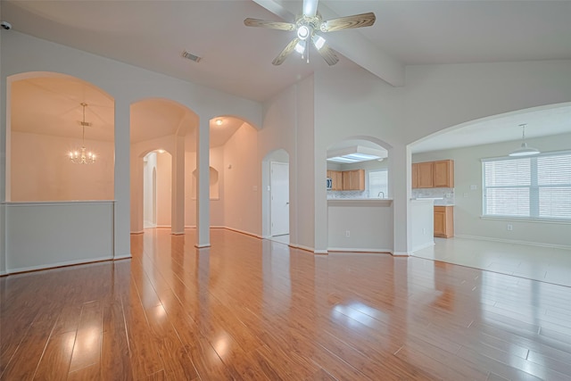 8143 Solara Bnd, Houston, TX 77083 - unfurnished living room with wood finished floors, a ceiling fan, arched walkways, and baseboards