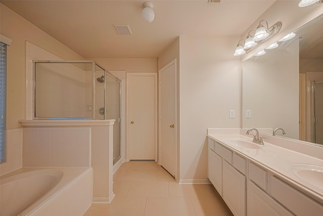 8143 Solara Bnd, Houston, TX 77083 - full bath featuring a shower stall, double vanity, a garden tub, tile patterned floors, and baseboards