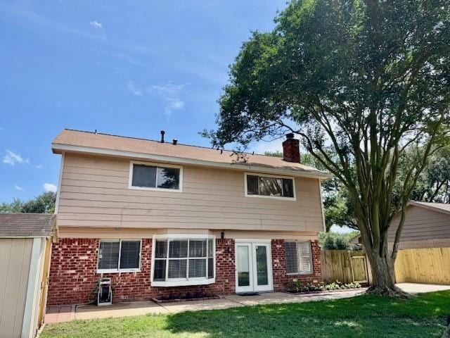 15326 Lindita Dr, Houston, TX 77083 - rear view of property with a chimney, brick siding, a patio area, and french doors