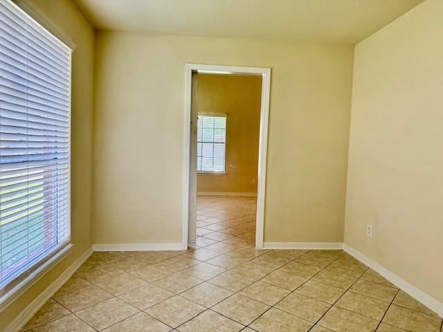 15326 Lindita Dr, Houston, TX 77083 - empty room featuring plenty of natural light, light tile patterned floors, and baseboards