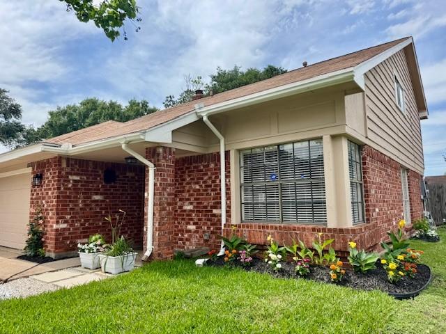 15326 Lindita Dr, Houston, TX 77083 - view of front of property featuring brick siding, an attached garage, and a front lawn
